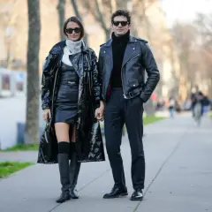 Para stylizacji: jakie spodnie do kurtki skórzanej? Ona w skórzanej sukience i płaszczu, on w czarnym golfie i skórzanej ramonesce.